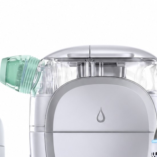 Close-up of the humidifier's clear water tank and green angled nozzle